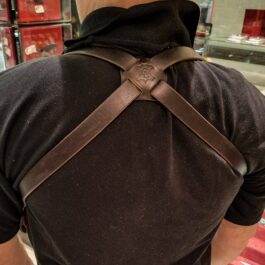 A man wearing a Handmade Leather Shoulder Holster in a store.
