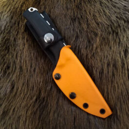 a Kydex sheath for the Benchmade Steep Country laying on top of a furry animal.