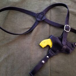 A purple Handmade Leather Shoulder Holster with a yellow handle.
