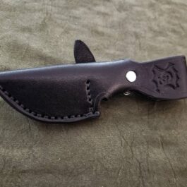 A knife with a Leather Sheath for the Benchmade Hidden Canyon Hunter on a table.