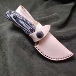 A Leather Sheath For The Benchmade Hidden Canyon Hunter with a black and white design on it.