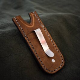 A Leather Pocket Slip for the Benchmade Tengu w' Pocket Clip with a metal clip on it.