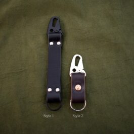 a Handmade Leather Keychain sitting next to another one.