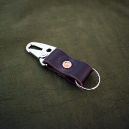 A small Handmade Leather Keychain with a metal handle.