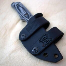 a Scout Style Kydex Sheath for Benchmade Hidden Canyon Hunter Style 2 with a black handle on a wooden surface.