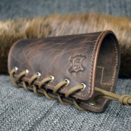 An Upgraded Handmade Leather Buttstock Cover with fur on top of it.