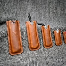 A set of four Handmade Leather Pocket Slips sitting on top of a gray cloth.