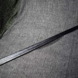 A Handmade leather Scabbard for the Albion Liechtenauer laying on top of a gray cloth.