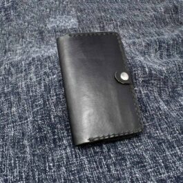 A Field Notes Wallet sitting on top of a blue cloth.