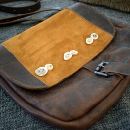 Arthur's Satchel, a brown leather bag with buttons on it.