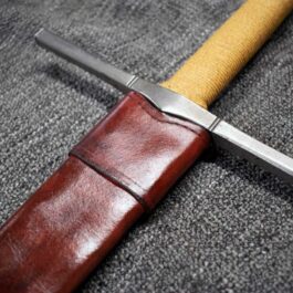 a Handmade leather Scabbard for the Albion Liechtenauer on a gray surface.