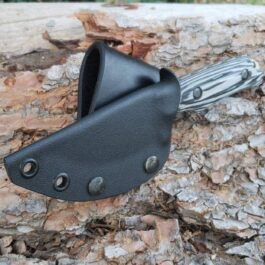 A Vertical Kydex Sheath for Benchmade Hidden Canyon Hunter attached to a tree trunk.