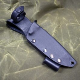 The Benchmade Bushcrafter Kydex Sheath is laying on a green cloth.
