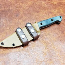 a Scout Style Benchmade Bushcrafter Kydex Sheath that is sitting on a leather surface.
