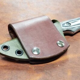 A Scout Style Kydex Sheath for Benchmade Hidden Canyon Hunter on a table.