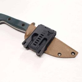 a Benchmade Bushcrafter Kydex Sheath with a black handle on a white surface.