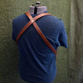 A mannequin wearing a blue shirt with Handmade Leather Side Clip Suspenders.