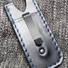A Handmade Leather Pocket Slip With Clip with a blue stitch on it.