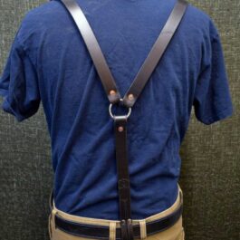 The back of a man's blue shirt with Handmade Leather Suspenders.