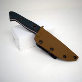 A Benchmade Bushcrafter Kydex Sheath sitting on top of a white block.