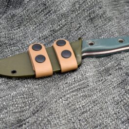 a Scout Style Benchmade Bushcrafter Kydex Sheath that is laying on the ground.