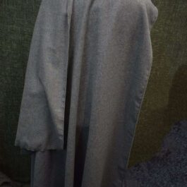 A Wool Bocksten Cloak on a mannequin in a room.