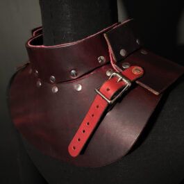 a woman wearing an Upgraded Handmade Leather Buttstock Cover with metal rivets.
