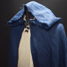 a Linen Hooded Cloak with a white shirt underneath it.