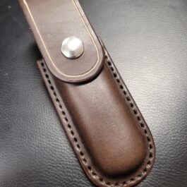 A Molded Leather Belt Pouch for a Benchmade Balisong with a metal button on it.