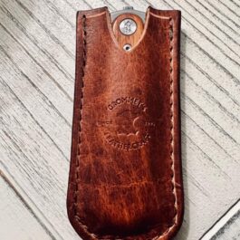 a Handmade Bison Leather Pocket Slip with a metal button on it.