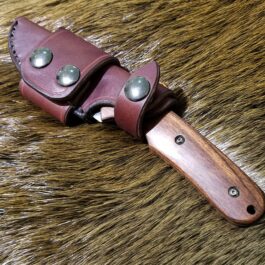 a leather knife sheath with a wooden handle.