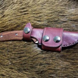 a leather knife sheath on a furry surface.