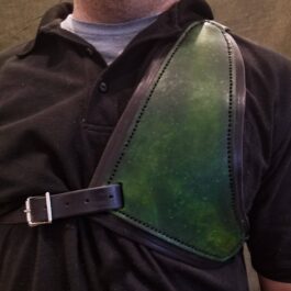 a man wearing a green leather shoulder brace.
