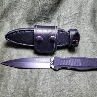 a knife and sheath laying next to each other.