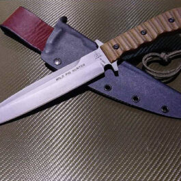 A Kydex Sheath for the TOPS Wild Pig Hunter that is laying on a table.