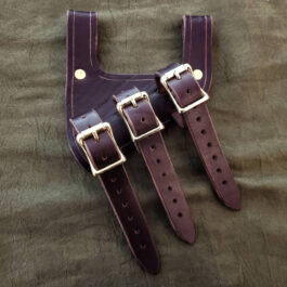 a pair of leather straps on a bed.