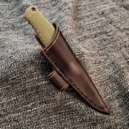 a knife with a leather sheath attached to it.