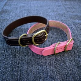A pair of handmade pink and black leather dog collars.