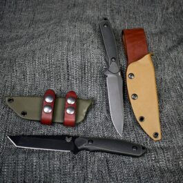 a couple of Kydex Sheaths for the Benchmade Protagonist sitting next to each other.