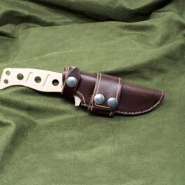 a Handmade Leather Sheath for the Benchmade Fixed Adamas on a green cloth.