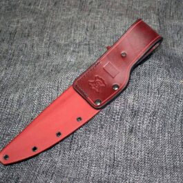 an Kydex Sheath for the TOPS Wild Pig Hunter laying on top of a gray cloth.