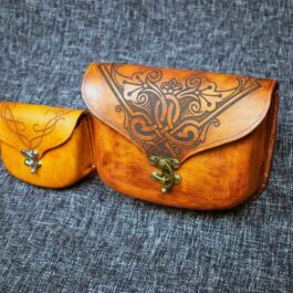 A small wooden case with a Molded Leather Belt Pouch handle.