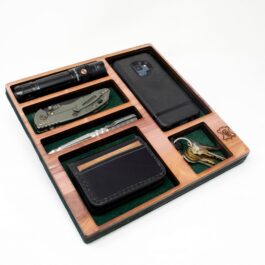 A Wooden Valet Tray with a knife, wallet, and other items in it.