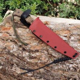 A Kydex sheath for the TOPS Wild Pig Hunter sitting on top of a rock.
