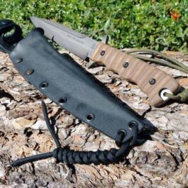 A Kydex sheath for the TOPS Wild Pig Hunter that is laying on a rock.