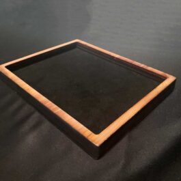 a square wooden tray sitting on top of a table.
