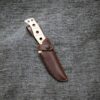 a Handmade Leather Sheath for the Benchmade Fixed Adamas on a gray sweater.