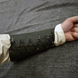 A person with Soft Leather Mirkwood Vambraces holding something in their hand.