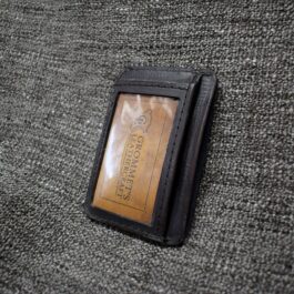 The "Michael" Wallet sitting on top of a gray couch.