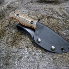The Vertical Kydex Sheath for Benchmade Hidden Canyon Hunter is laying on a fur surface.
